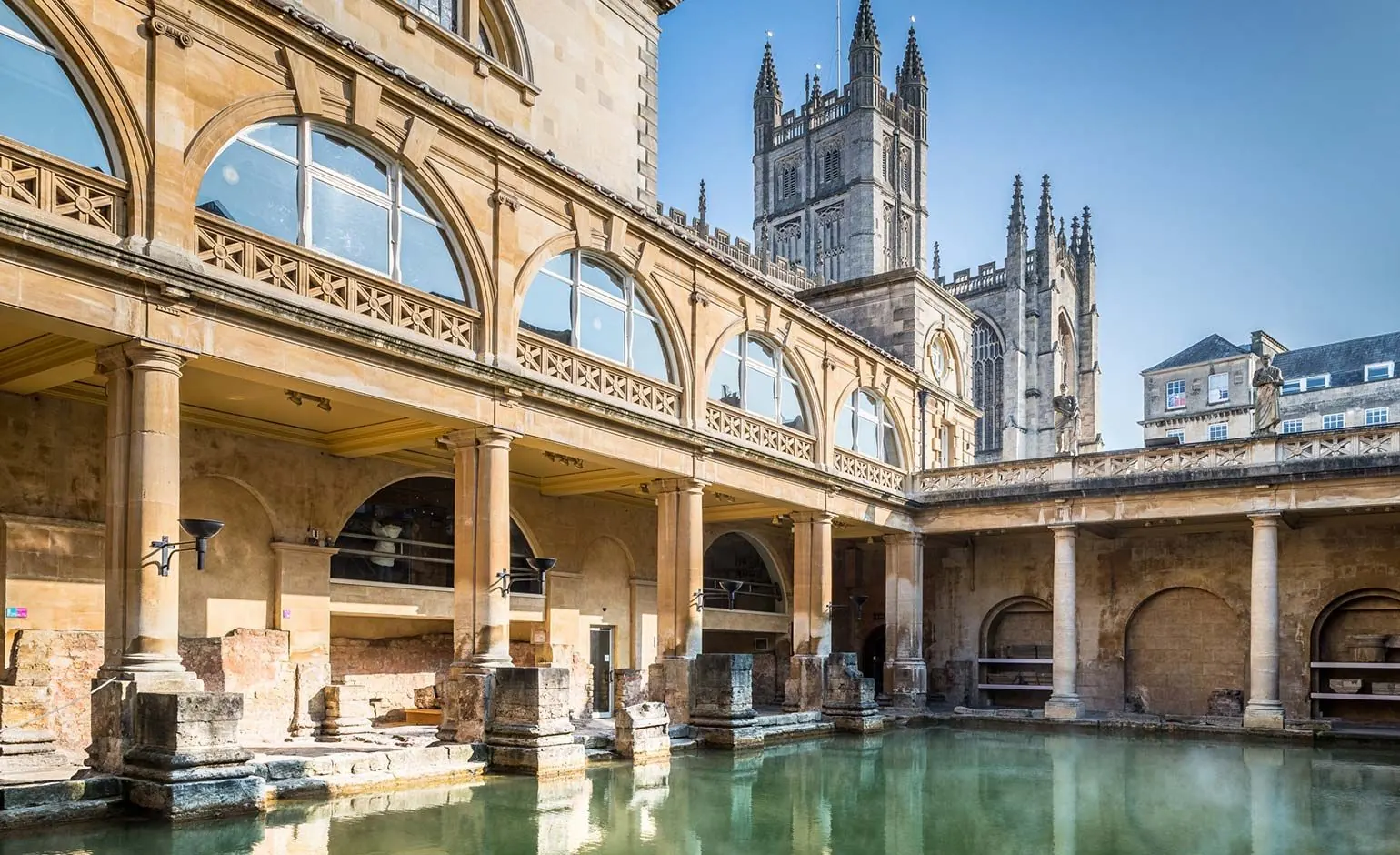 The Roman Baths in Bath, with Bath Abbey rising behind the colonnade